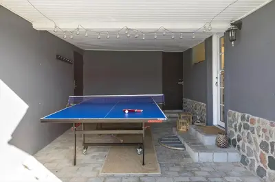 a ping pong table sitting in a room with at BL1498-Blokhus-Bag-Somaerket-22 in Blokhus