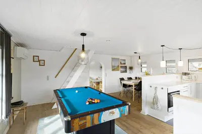 a living room with a pool table in it at BL1498-Blokhus-Bag-Somaerket-22 in Blokhus