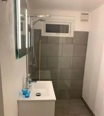 a bathroom with a sink and a shower at BL1498-Blokhus-Bag-Somaerket-22 in Blokhus