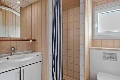 a bathroom with a sink and a shower at BL1772-Saltum-Faarup-Klitvej-22 in Saltum