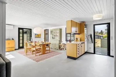 a kitchen and dining room with a table and a dining room at BL1365-Pandrup-Hunetorp-Klitvej-69 in Pandrup