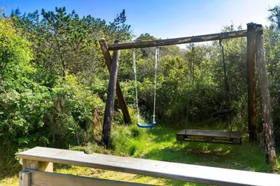 a swing in a yard with a bench at BL1758-Saltum-Porsevej-23 in Saltum