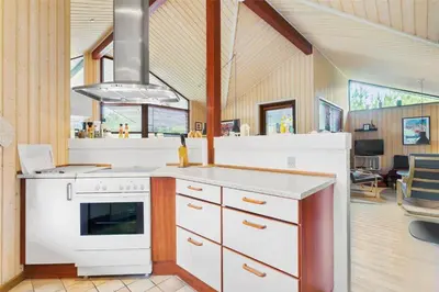 a kitchen with a white stove top oven in a room at BL160-Blokhus-Bag-Hojen-68 in Blokhus