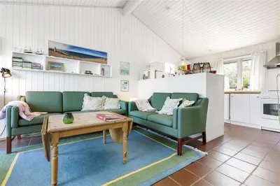 a living room with two green couches and a table at BL745-Saltum-Karen-Mariesvej-70 in Saltum
