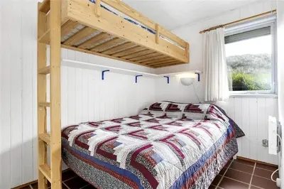 a bedroom with a bunk bed and a ladder at BL745-Saltum-Karen-Mariesvej-70 in Saltum