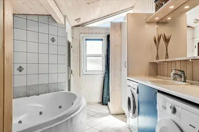 a bathroom with a tub and a sink at BL152-Saltum-Kvansletten-33 in Saltum