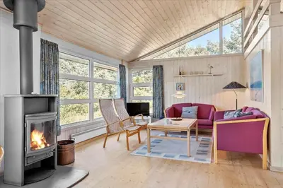 a living room with a couch and a fireplace at BL152-Saltum-Kvansletten-33 in Saltum