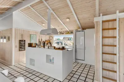 a kitchen with a white counter and a refrigerator at BL1047-Saltum-Bag-Havstokken-2-A in Saltum