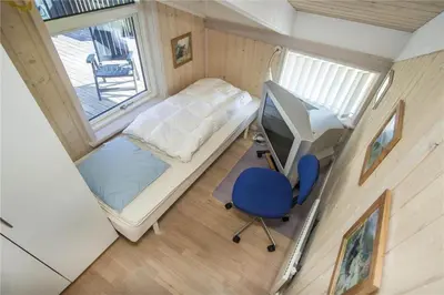 a small room with a bed and a desk and a window at BL486-Saltum-Laustvej-32 in Saltum