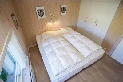 a large white bed in a small room at BL486-Saltum-Laustvej-32 in Saltum