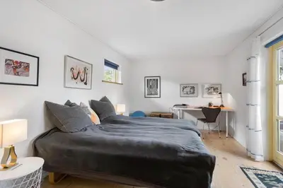a bedroom with two beds and a desk at BL1318-Blokhus-Vesterhavsbakken-28 in Blokhus