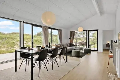 a living room with a dining room table and chairs at BL1411-Blokhus-Ribergaardsvej-15 in Blokhus