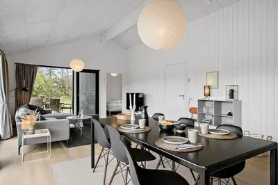a living room with a black table and chairs at BL1411-Blokhus-Ribergaardsvej-15 in Blokhus