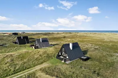 three houses in a field next to the ocean at BL1193-Pandrup-Narhvalen-14 in Pandrup