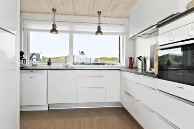 a kitchen with white cabinets and a window at BL1193-Pandrup-Narhvalen-14 in Pandrup