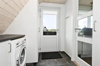 a white laundry room with a washer and dryer at BL1193-Pandrup-Narhvalen-14 in Pandrup