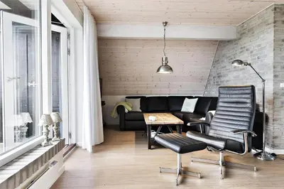 a living room with a couch and a table and chairs at BL1193-Pandrup-Narhvalen-14 in Pandrup