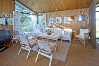 a living room with a couch and a table and chairs at BL363-Saltum-Nyborgvej-4 in Saltum