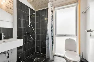 a bathroom with a shower and a toilet and a sink at BL540-Saltum-Trehoje-9 in Saltum