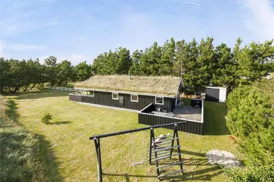 a large black building with a thatch roof at BL1066-Pandrup-Rodhus-Skolevej-17 in Pandrup