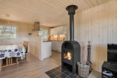 a living room with a wood stove in a kitchen at BL1066-Pandrup-Rodhus-Skolevej-17 in Pandrup