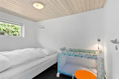 a bedroom with a bed and a table and a window at BL1625-Saltum-Fladen-Grund-8 in Saltum