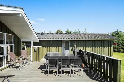 a patio with a table and chairs on a deck at BL1625-Saltum-Fladen-Grund-8 in Saltum