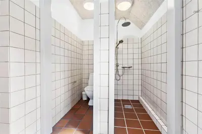 a bathroom with a shower and a toilet at BL1169-Blokhus-Berberisvej-5 in Blokhus