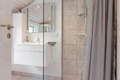 a bathroom with a shower and a sink at BL1336-Blokhus-Berberisvej-18 in Blokhus