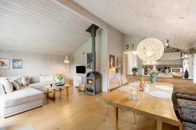 a living room with a couch and a table at BL1254-Pandrup-Rodhusparken-25 in Pandrup