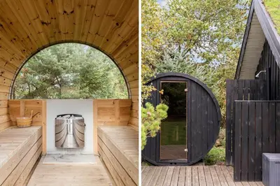 a wooden house with an arched doorway and a black door at BL1254-Pandrup-Rodhusparken-25 in Pandrup
