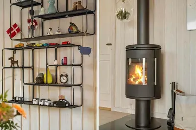 a fireplace in a room with a wall at BL1502-Blokhus-Graevlingevej-3 in Blokhus