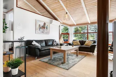 a living room with a couch and a table at BL1203-Blokhus-Pirupshvarrevej-23 in Blokhus