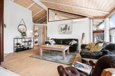 a living room with a couch and a coffee table at BL1203-Blokhus-Pirupshvarrevej-23 in Blokhus