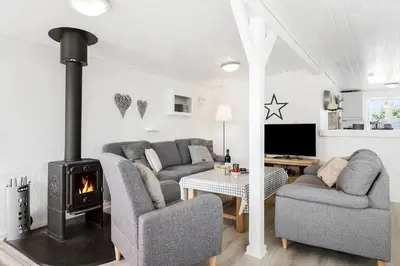 a living room with two couches and a fireplace at BL1496-Blokhus-Peder-Madsensvej-28 in Blokhus