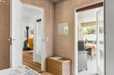 a bedroom with a door leading to a dining room at BL721-Pandrup-Rodhus-Skolevej-32 in Pandrup