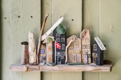 a wooden figurine of a house on a wall at BL721-Pandrup-Rodhus-Skolevej-32 in Pandrup