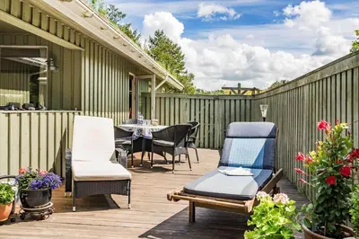 a patio with chairs and a table on a deck at BL721-Pandrup-Rodhus-Skolevej-32 in Pandrup