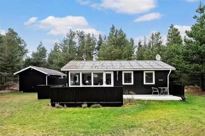 a small black house in the middle of a field at BL488-Pandrup-Akelejevej-10 in Pandrup