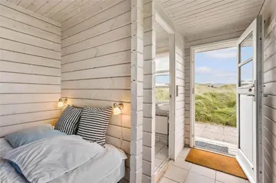 a small bedroom with a bed and a window at BL1665-Saltum-Borgvej-57 in Saltum