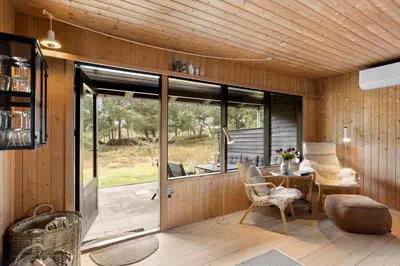 a screened in porch with a table and chairs at BL1331-Saltum-Tvegen-12 in Saltum