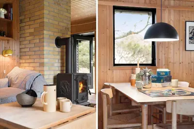 a living room with a table and a wood stove at BL1331-Saltum-Tvegen-12 in Saltum