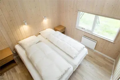 a bedroom with two beds in a room with a window at BL481-Pandrup-Rodhusparken-10 in Pandrup