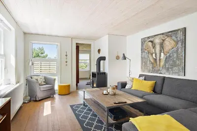 a living room with a couch and an elephant painting on the wall at BL1073-Blokhus-Egonsvej-10 in Blokhus
