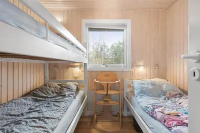 a bedroom with two bunk beds and a window at BL1682-Pandrup-Rodhus-Skolevej-24 in Pandrup