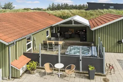 an overhead view of a green building with a hot tub at BL1216-Blokhus-Gyvelvej-13 in Blokhus