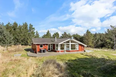 a small red house in the middle of a field at BL1600-Saltum-Daadyrvej-25-A in Saltum