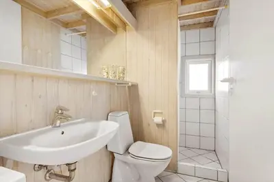 a bathroom with a white toilet and a sink at BL1600-Saltum-Daadyrvej-25-A in Saltum