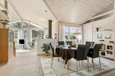 a dining room with a table and black chairs at BL1600-Saltum-Daadyrvej-25-A in Saltum