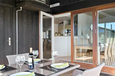 a dining room with a table with wine glasses at BL188-Saltum-Kordalssletten-3 in Saltum